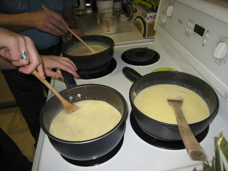 3 fondues being prepared on a stove top