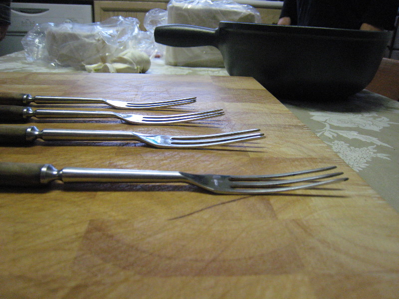4 different views of traditional fondue forks